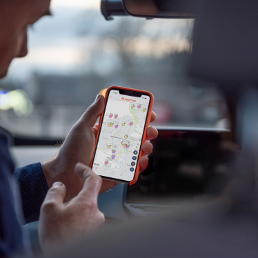A phone displaying the Zapmap map, with nearby EV chargers